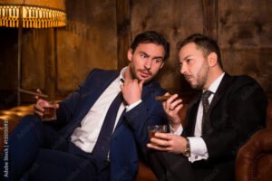 Two men having drinks and discussion in bar